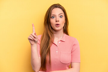 Young caucasian woman isolated on yellow background having some great idea, concept of creativity.