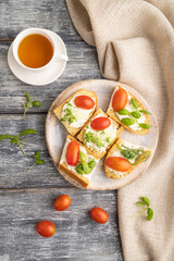 White bread sandwiches with cream cheese, tomatoes and microgreen on gray. top view.