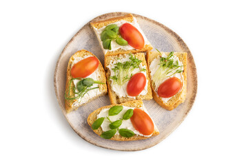 White bread sandwiches with cream cheese, tomatoes and microgreen isolated on white. top view.