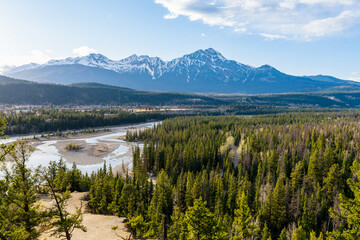 Fototapeta na wymiar Jasper National Park Canadian Rockies beautiful scenery. Panoramic view Athabasca River valley forest and Pyramid Mountain on sunset time. AB, Canada.
