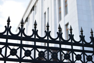 The iron fence of the government building in the park Russia. Iron pins on the fence.
