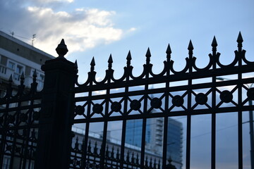 The iron fence of the government building in the park Russia. Iron pins on the fence.