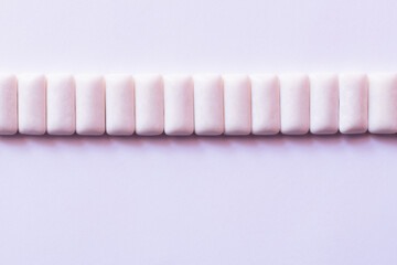 Flat lay with row from chewing gums on white background.