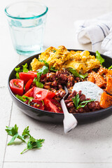 Baked vegetables buddha bowl. Sweet potato, cauliflower, tomato and bean salad. Vegan recipe.