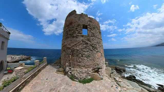 Aerial panorama of the tower of Erbalunga town city harbor in Corsica island of France. Aerial view of the seascape and the city cliff in Tyrrhenian and Mediterranean sea.