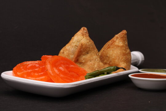 samosa and jalebi or jilebi served with red and green chutney