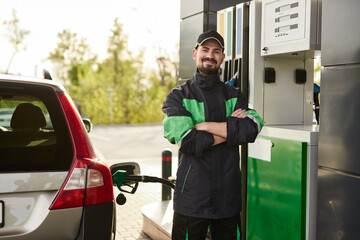 Positive gas station worker near car