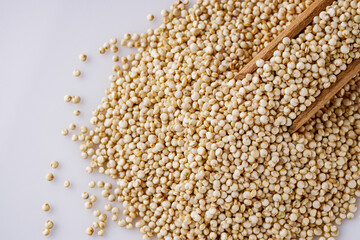 white quinoa seeds on a white acrylic background