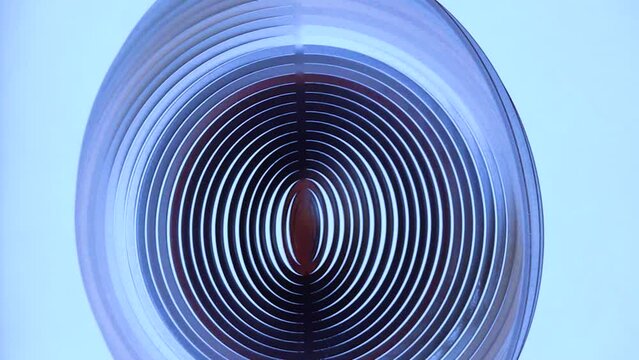 abstract rotation of a round blue figure on a blue background. slow motion