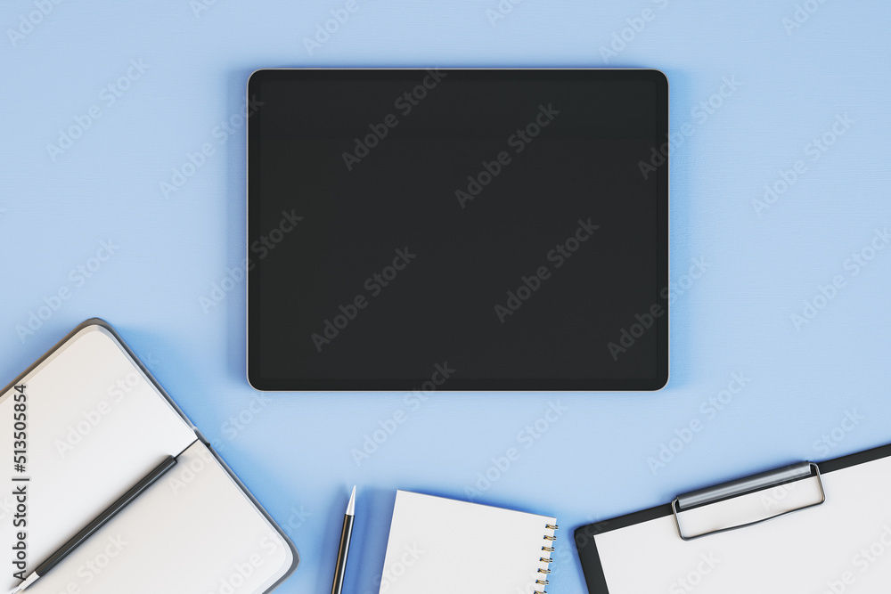 Poster Top view and close up of empty black tablet on blue desktop with supplies. Work place and stationery objects concept. Mock up, 3D Rendering.