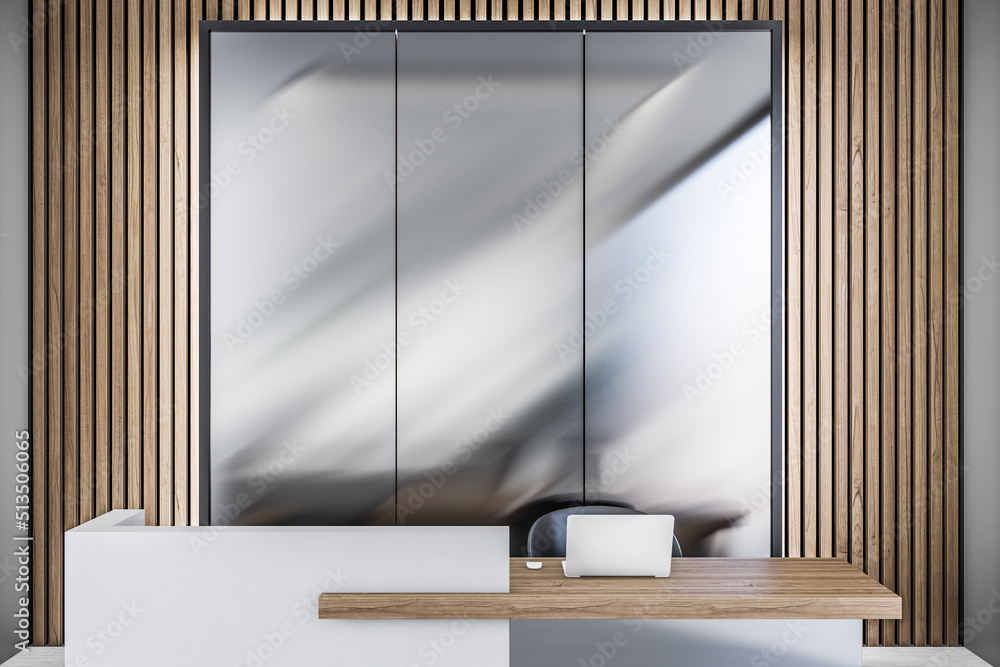 Aufkleber Front view on stylish office reception area with modern laptop on wooden table surface on metallic wall background. 3D rendering