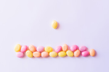 Top view of candy near colorful sweets on white background.