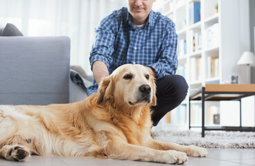 Man cuddling his cute dog