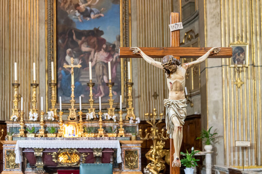 Catholic altar with candles and crucifix inside church in Rome