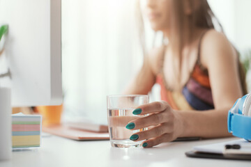 Fototapeta premium Woman drinking water at home