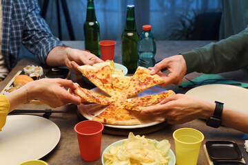 Group of friends eating pizza together