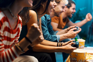 Cheerful friends playing video games together