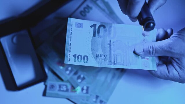 hundred euro bill is studied under ultraviolet light