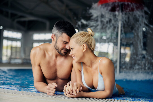 Romantic moments in the pool with thermal water in the spa center. 
