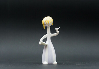 Mid-century modern porcelain figurine - Cinderella with a dove - isolated on black background