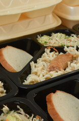 Lunch boxes (salad, chicken leg, pasta). Free lunches for needy and internally displaced persons. Lunch delivery concept. Online orders