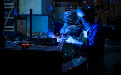 A welder is working to weld metal. to create quality work according to the prescribed form