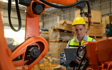 A male engineer checking the operation of a welding robot. used for precision welding control Fast and highly secure