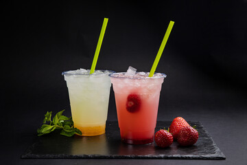 Lemonades in transparent glasses on a black background
