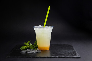 Lemonades in transparent glasses on a black background
