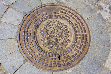 Beautiful manhole bronze cover in Wroclaw	
