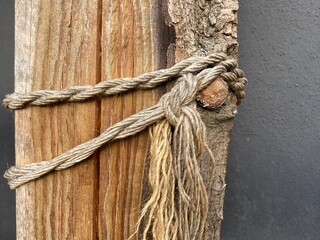 A rope is wrapped around a wooden beam