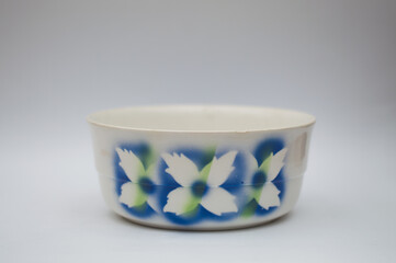 Mid-century modern style bowl with blue spray-painted flower pattern