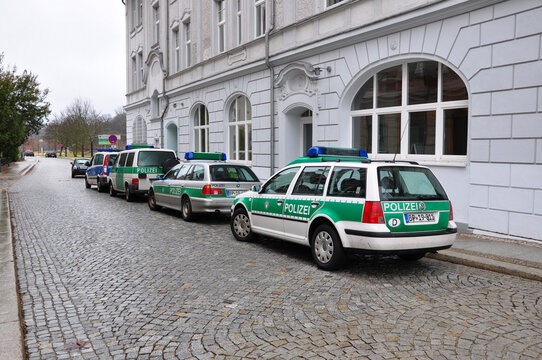 Guben, Germany - January 5, 2013: police patrol cars parked along city street road at building exterior