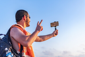 Man having fun taking a selfie, outdoor on holiday.
