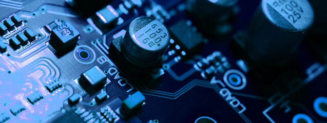 closeup on electronic circuit board with components and semiconductors, long banner