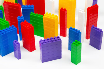 colored blocks of a plastic constructor on a white background in the form of multi-storey buildings. concept of modern buildings and houses