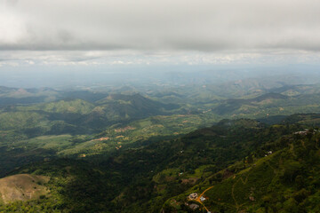 Aerial view of Tropical green forest in the mountains and jungle hills in the highlands of Sri Lanka.