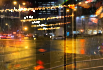 Fototapeta na wymiar rainy city night light street reflection car traffic buildings blurred light red yellow bokeh vew from window urban holiday lifestyle