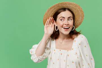 Young happy curious nosy fun woman she 20s wears white dress hat try to hear you overhear listening intently isolated on plain pastel light green background studio portrait. People lifestyle concept.