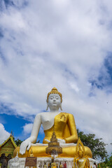 Fototapeta premium Mae Hia,Chiang Mai,Northern Thailand on Septemmber 13,2019:Sitting Buddha Statue at Wat Phra That Doi Kham.