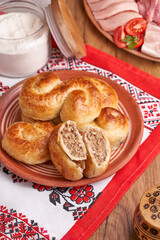 Freshly baked homemade pies with stewed meat, popular moldavian food served as snack or appetizer.                  