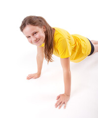 young girl doing push ups on a white background