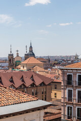 Covers the city of Madrid with domes and spiers of several churches on a sunny day