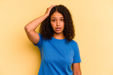 Young Brazilian woman isolated on yellow background being shocked, she has remembered important...