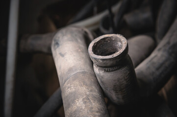 Rubber pipes and hoses leading from the car radiator to the engine, view of the engine from below....