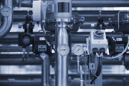 Pressure and Flow system on factory pipeline. Pressure guage and Flow sensor installed on industrial pipline.