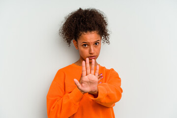 Young Brazilian woman isolated on blue background standing with outstretched hand showing stop...