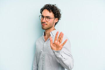 Young caucasian man isolated on blue background rejecting someone showing a gesture of disgust.