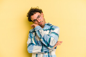 Fototapeta premium Young caucasian man isolated on yellow background tired of a repetitive task.
