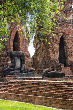 Phra Nakorn Sri Ayutthaya,Thailand on May22,2020:Ancient Buddha Statue and ruins at Wat Mahathat.A UNESCO World Heritage Site.